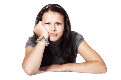 girl putting her hand in face