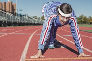 woman getting ready to run on a track field