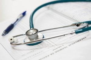 stethoscope  , pen and note