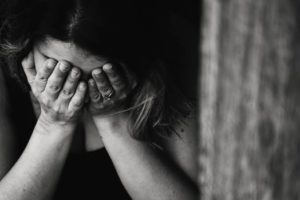 woman holding her face